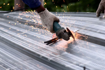 Close-up of man working on metal