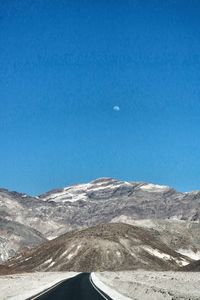 Scenic view of snowcapped mountains against clear blue sky