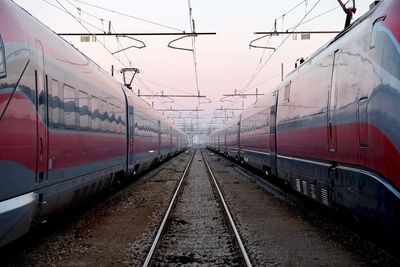 Trains on railroad track against sky