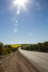 Road amidst trees against sky