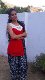 Portrait of a smiling young woman standing outdoors