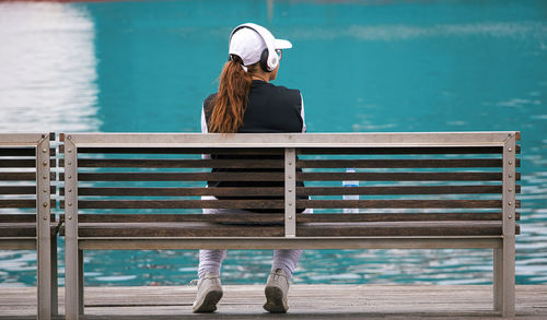 Full length of woman sitting on bench