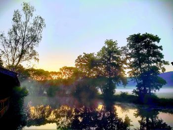 Scenic view of lake against sky during sunset