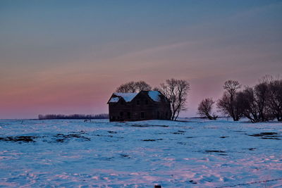 House by sea against sky during winter