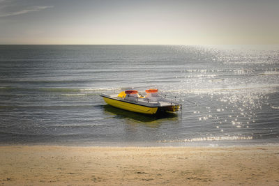 Boat sailing in sea against sky