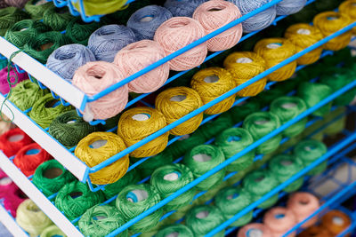 Yarns or balls of wool on shelves in store for knitting and needlework. accessories haberdashery