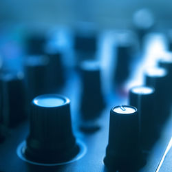 Close-up of candles on table against blue background