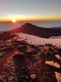 Scenic view of land against sky during sunset