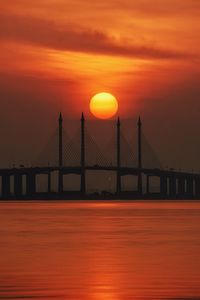 Scenic view of suspension bridge against sky during sunset