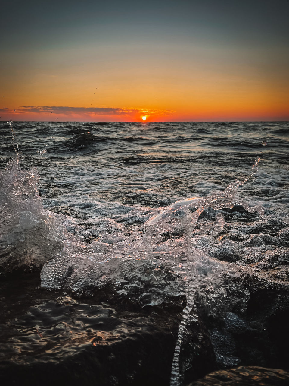 SCENIC VIEW OF SUNSET OVER SEA