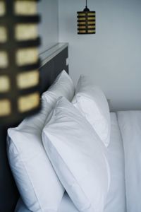 Close-up of white sofa on bed at home