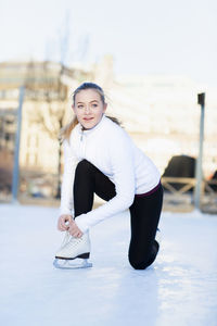 Woman lacing ice skate