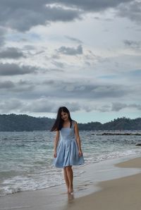 Portrait of woman standing on beach