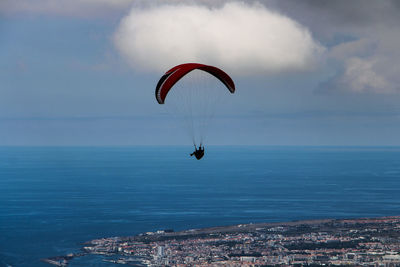 Man paragliding over sea