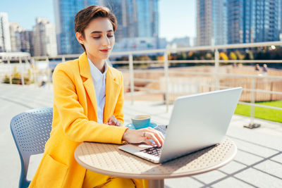 Young businesswoman using laptop at office