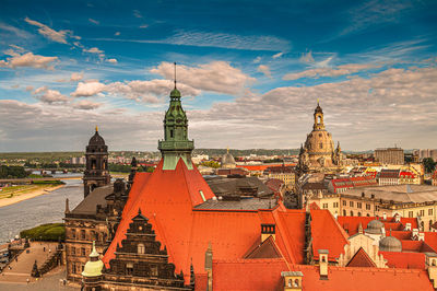 High angle view of buildings in city against cloudy sky