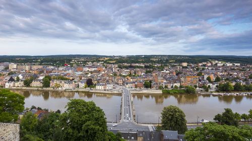 High angle view of river and buildings against sky