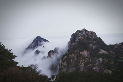 Scenic view of mountain against sky during foggy weather