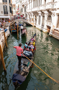 Boats in canal along buildings