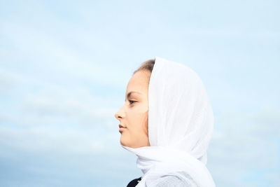 Portrait of woman standing against sky