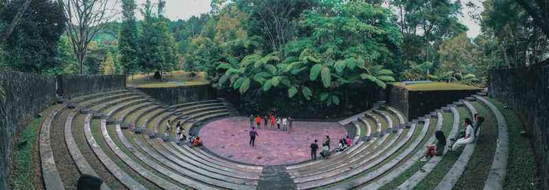 High angle view of people in amphitheater against trees