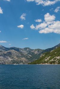 Scenic view of sea and mountains against sky