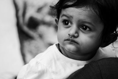 Close-up portrait of cute baby looking away