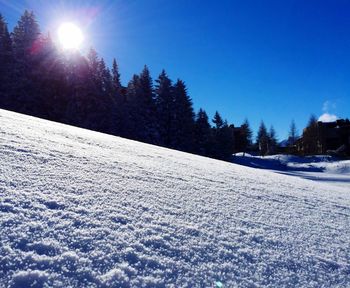 Scenic view of snow covered landscape against clear sky