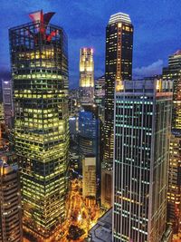 Illuminated cityscape against sky at night
