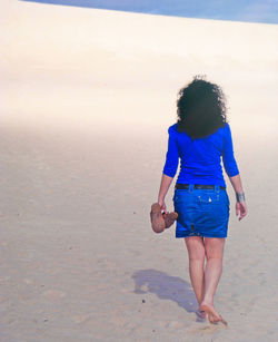 Full length of woman standing on beach