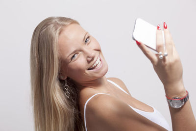 Portrait of smiling young woman using smart phone