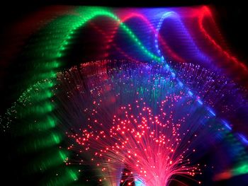 Illuminated firework display at night