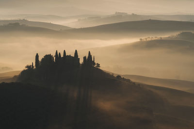 Misty sunrise at podere belvedere, val d'orcia