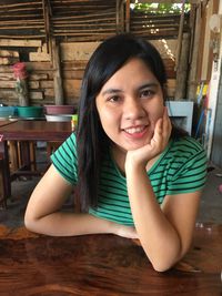 Portrait of smiling young woman sitting