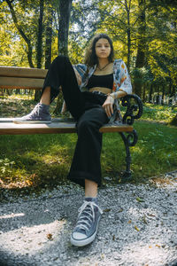 Portrait of young woman sitting in park