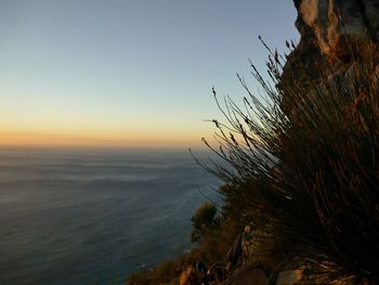 Scenic view of sea against clear sky at sunset