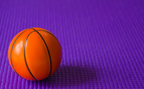 Close-up of yellow ball against blue wall
