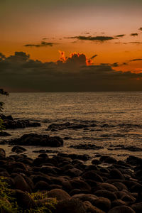 Sunset on the rocky beach of albion, mauritius.