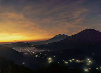 Scenic view of silhouette mountains against sky at sunset