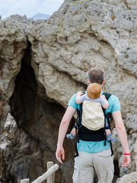 Rear view of couple standing on cliff