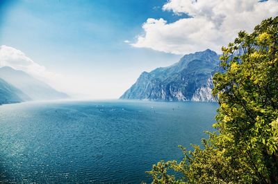 Scenic view of sea and mountains against sky