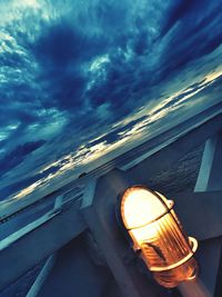 Low angle view of illuminated lamp against sky