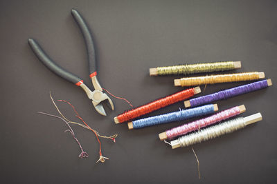Pliers and wire spools on table