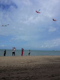 People flying kites at beach
