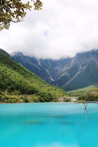 Swimming pool by mountains against sky