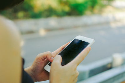 Close-up of hand holding mobile phone