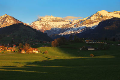 Scenic view of field and mountains during winter