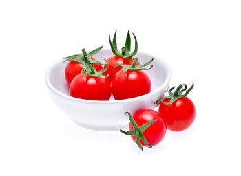 Close-up of red tomatoes against white background