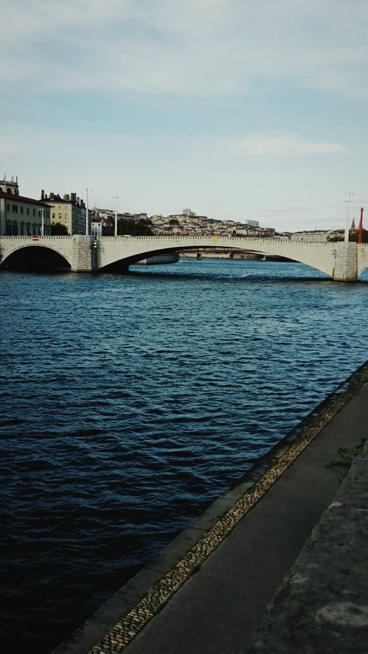 bridge - man made structure, connection, architecture, built structure, river, transportation, sky, water, city, outdoors, day, bridge, cloud - sky, building exterior, no people, cityscape, nature