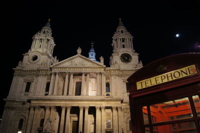 Low angle view of illuminated building against sky at night